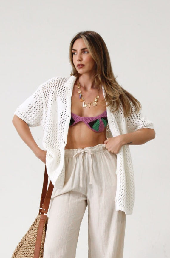 Open knit crochet shirt. Oversized fit. Collar neckline. Short sleeves. Front button down closures. Unlined. Beach shirt cover up. Pool shirt cover up. Vacation outfit. White crochet top.