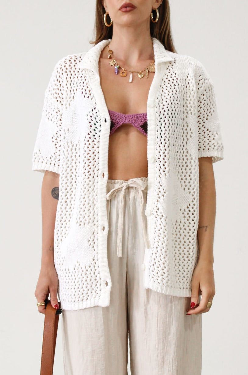 Open knit crochet shirt. Oversized fit. Collar neckline. Short sleeves. Front button down closures. Unlined. Beach shirt cover up. Pool shirt cover up. Vacation outfit. White crochet top.