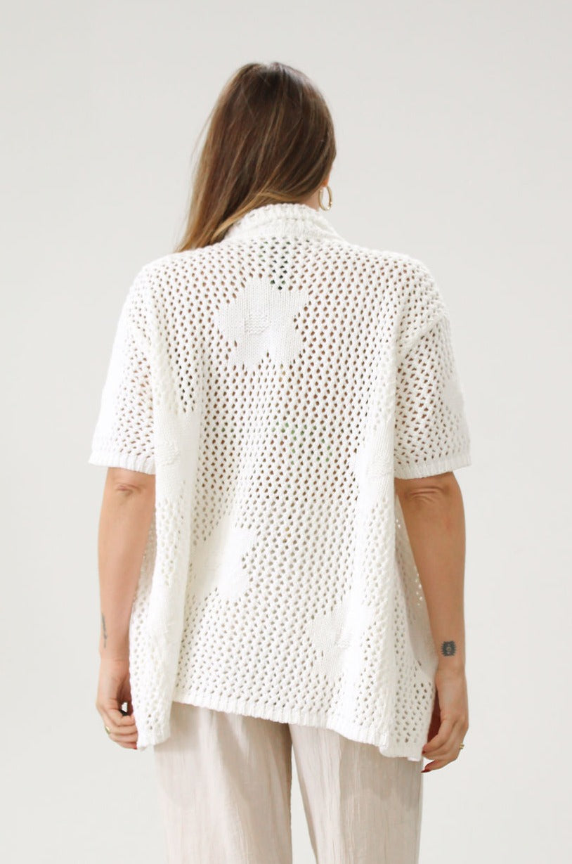 Open knit crochet shirt. Oversized fit. Collar neckline. Short sleeves. Front button down closures. Unlined. Beach shirt cover up. Pool shirt cover up. Vacation outfit. White crochet top.