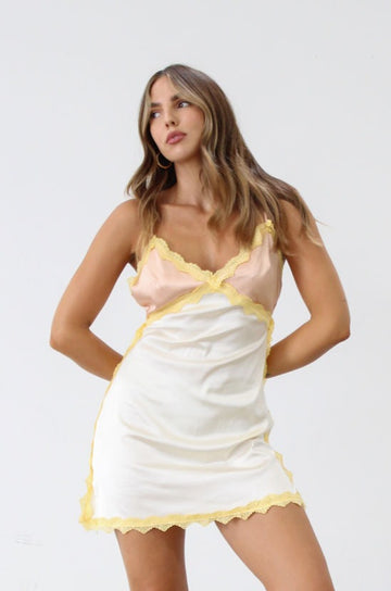 Satin dress. Lace trim. Adjustable straps. Back hook and eye and zipper closures. Unlined. Silk slip dress. Yellow slip dress. Slip dress with lace. Sexy dress. Yellow mini dress.