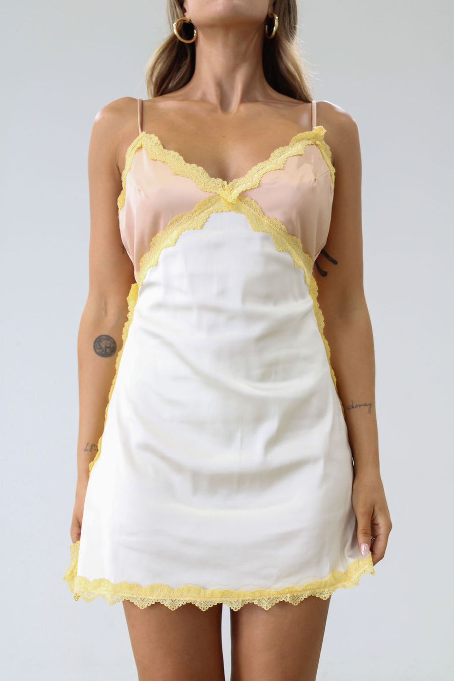 Satin dress. Lace trim. Adjustable straps. Back hook and eye and zipper closures. Unlined. Silk slip dress. Yellow slip dress. Slip dress with lace. Sexy dress. Yellow mini dress.