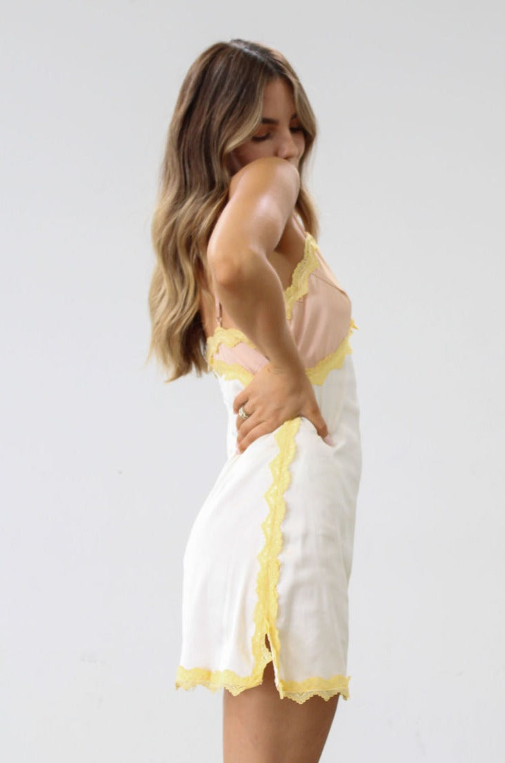 Satin dress. Lace trim. Adjustable straps. Back hook and eye and zipper closures. Unlined. Silk slip dress. Yellow slip dress. Slip dress with lace. Sexy dress. Yellow mini dress.