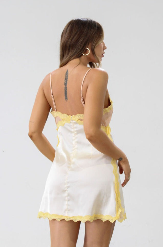 Satin dress. Lace trim. Adjustable straps. Back hook and eye and zipper closures. Unlined. Silk slip dress. Yellow slip dress. Slip dress with lace. Sexy dress. Yellow mini dress.
