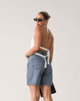 Denim shorts. Button and zipper fly closure. Five pockets. Unlined. High waisted, relaxed, wide leg, mid thigh length, non-stretch rigid denim.