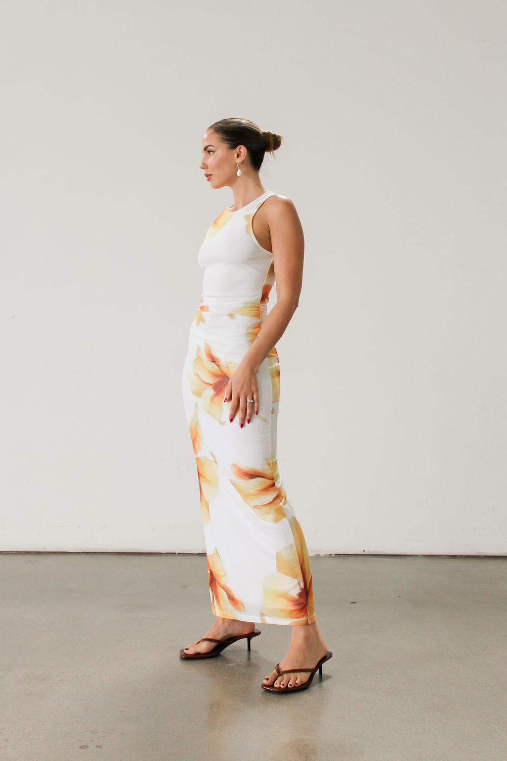 Floral knit mesh maxi dress. Sleeveless. Ruched sides. Fully lined.
