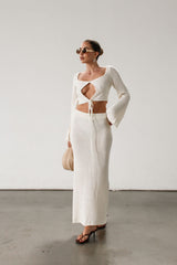 Cream maxi skirt set with long sleeve crop top.TOP: Textured crochet knit crop top. Long bell sleeves. Front keyhole and tie closure. Unlined  BOTTOM: Textured crochet knit maxi skirt. Elastic waist. Unlined.
