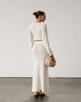 Cream maxi skirt set with long sleeve crop top.TOP: Textured crochet knit crop top. Long bell sleeves. Front keyhole and tie closure. Unlined  BOTTOM: Textured crochet knit maxi skirt. Elastic waist. Unlined.