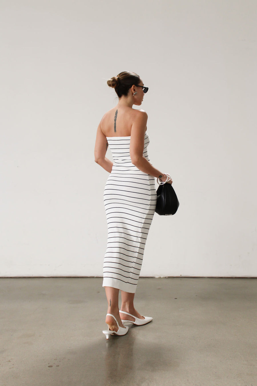 Striped ribbed knit maxi dress. Strapless elastic neckline. Front knot detail. Unlined.