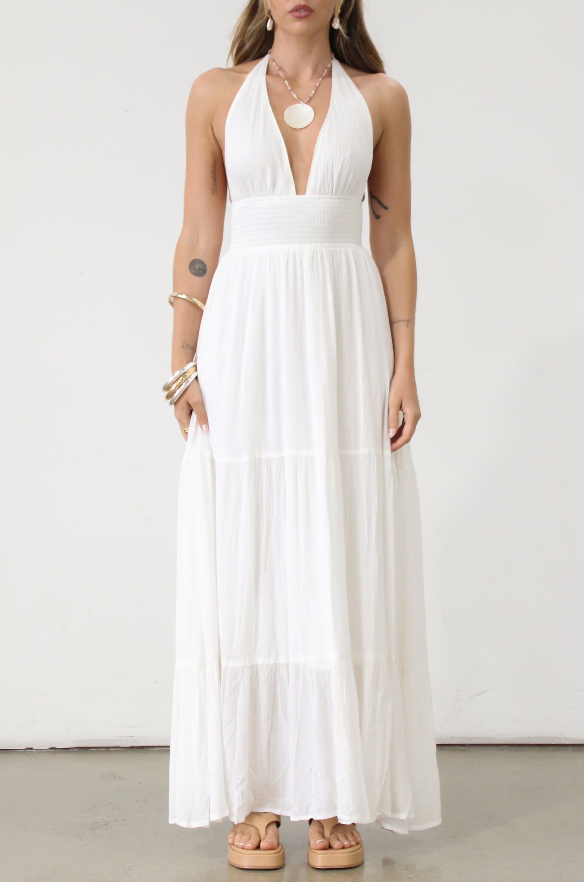 Crinkle woven maxi dress. Adjustable halter tie neck. Elastic smocked waist. Elastic back. Back cut out. Fully lined. White maxi dress. White halter neck dress. Summer dress. dress to wear on vacation. flowy dress. deep v neck dress. European summer outfit 