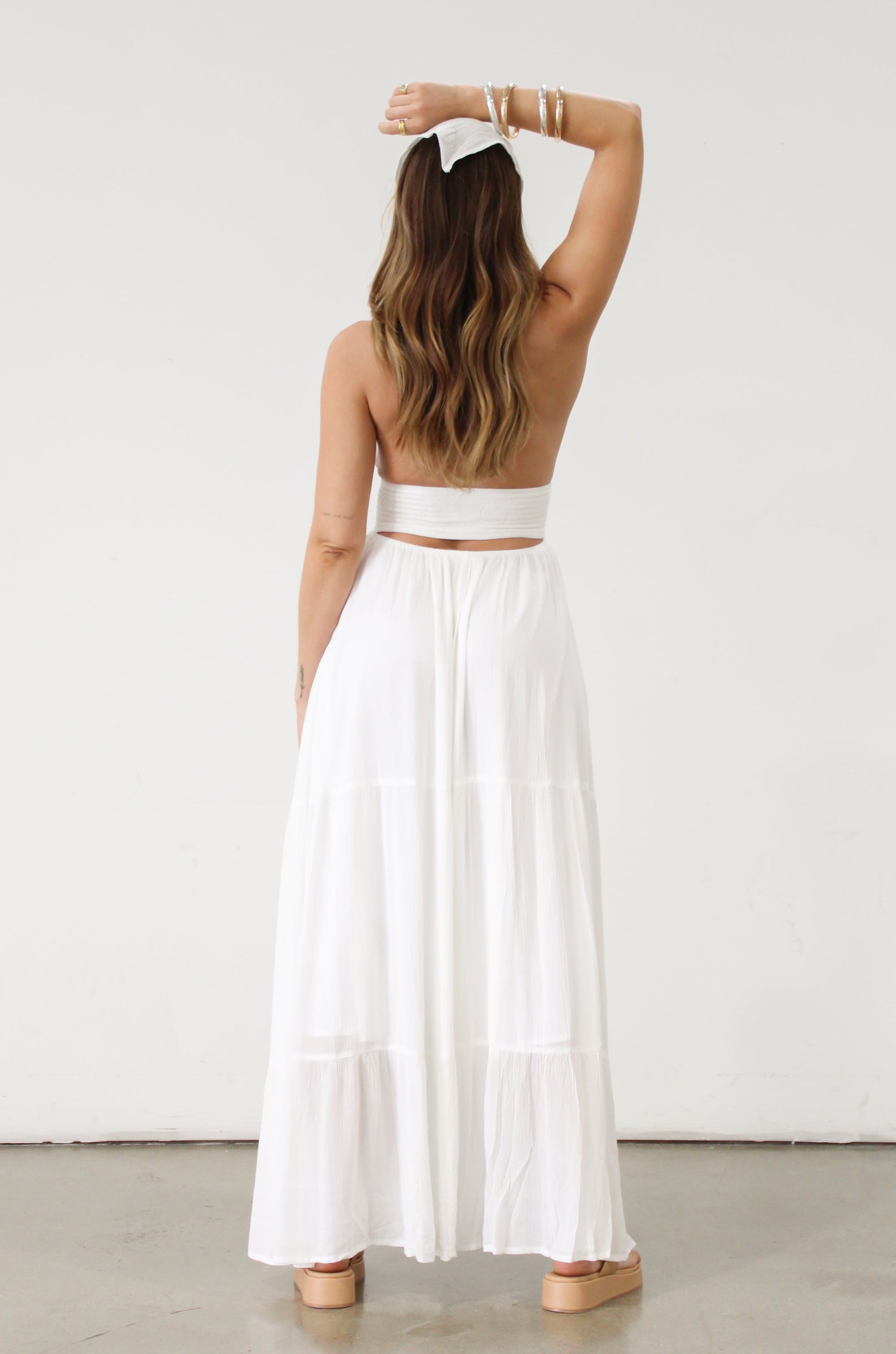 Crinkle woven maxi dress. Adjustable halter tie neck. Elastic smocked waist. Elastic back. Back cut out. Fully lined. White maxi dress. White halter neck dress. Summer dress. dress to wear on vacation. flowy dress. deep v neck dress. European summer outfit 