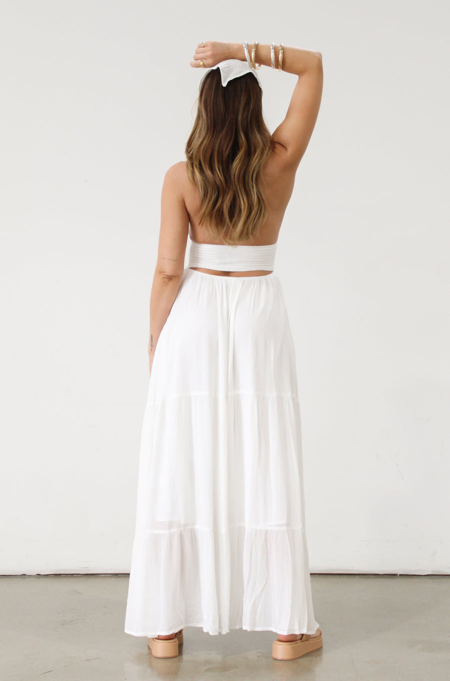 Crinkle woven maxi dress. Adjustable halter tie neck. Elastic smocked waist. Elastic back. Back cut out. Fully lined. White maxi dress. White halter neck dress. Summer dress. dress to wear on vacation. flowy dress. deep v neck dress. European summer outfit 