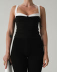 Knit crop top. Elastic straps. Fully lined. Black with white straps and sweetheart detail.
