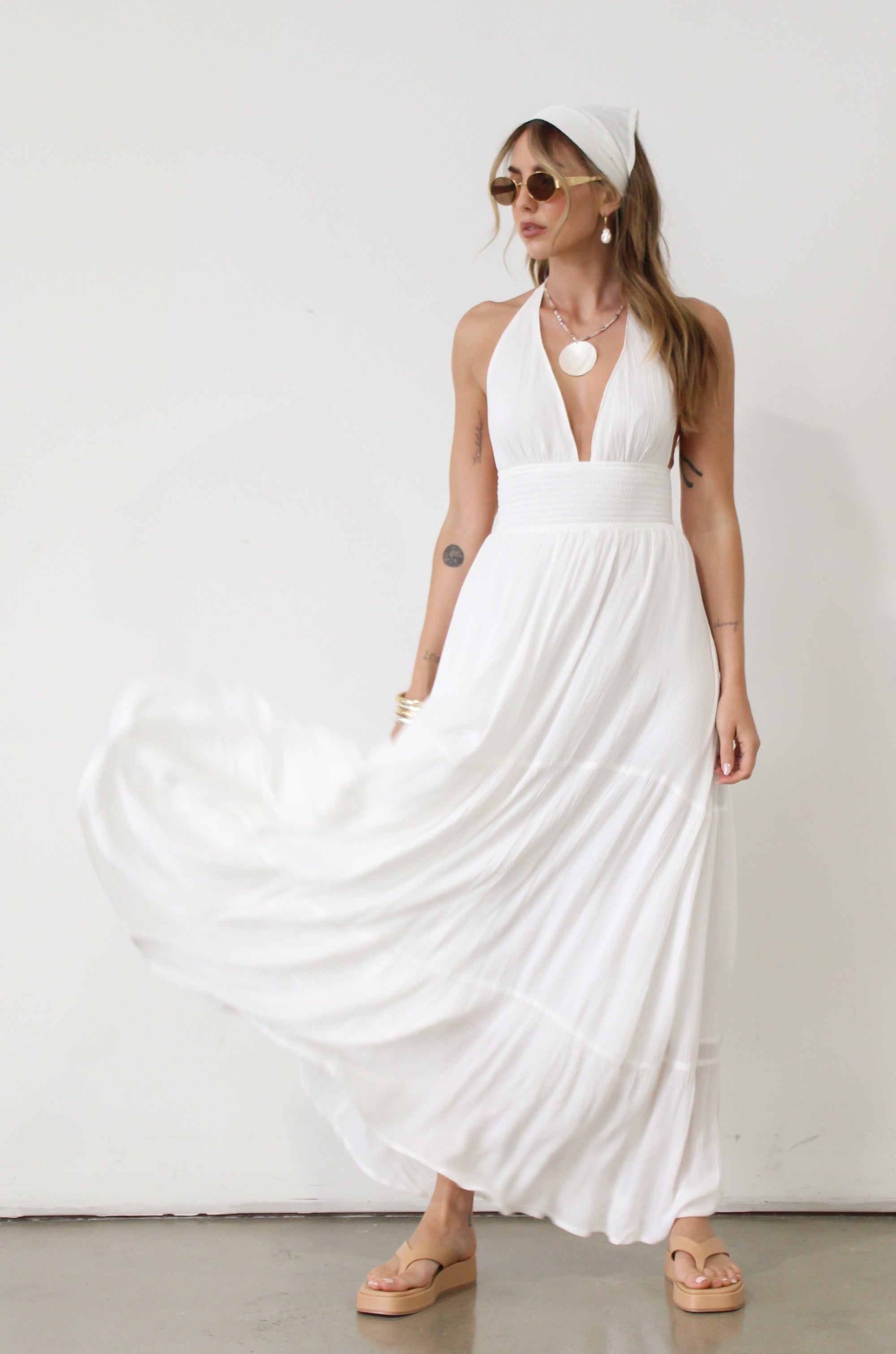 Crinkle woven maxi dress. Adjustable halter tie neck. Elastic smocked waist. Elastic back. Back cut out. Fully lined. White maxi dress. White halter neck dress. Summer dress. dress to wear on vacation. flowy dress. deep v neck dress. European summer outfit 