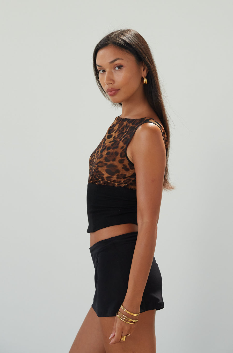 Animal printed chiffon sleeveless top. Elastic knit hem. Back lace up closure. Unlined/sheer. leopard top. going out top. night out top. summer top. date night top