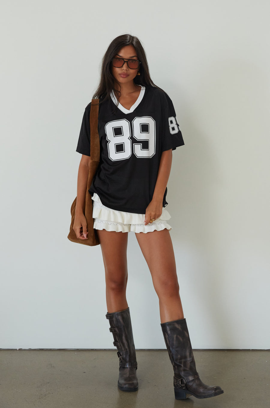 Mesh jersey t-shirt. V-neckline. Short sleeves. Side slits. Unlined/sheer. black jersey top. sporty casual outfit. summer top