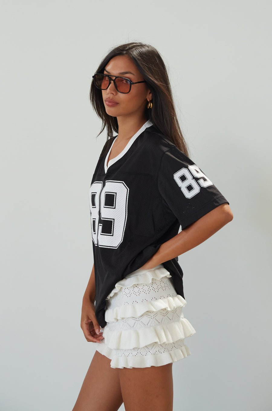 Mesh jersey t-shirt. V-neckline. Short sleeves. Side slits. Unlined/sheer. black jersey top. sporty casual outfit. summer top