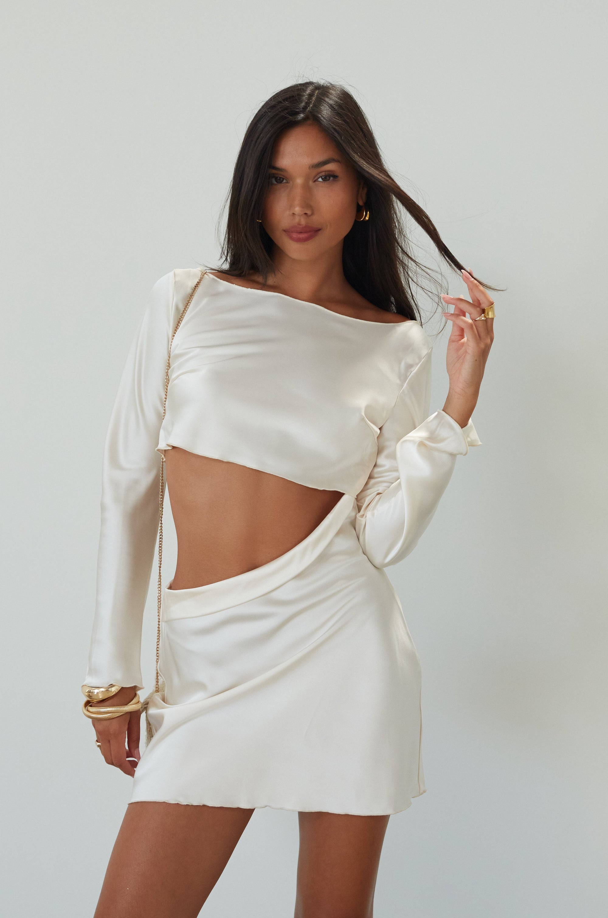 Satin dress. Long sleeves. Side cut out. Side zipper closure. Unlined. off white satin dress. off white mini dress. dress with cut out. cream satin mini dress. bride. bridal dress. engagement dress. bridal shower dress. wedding after party dress