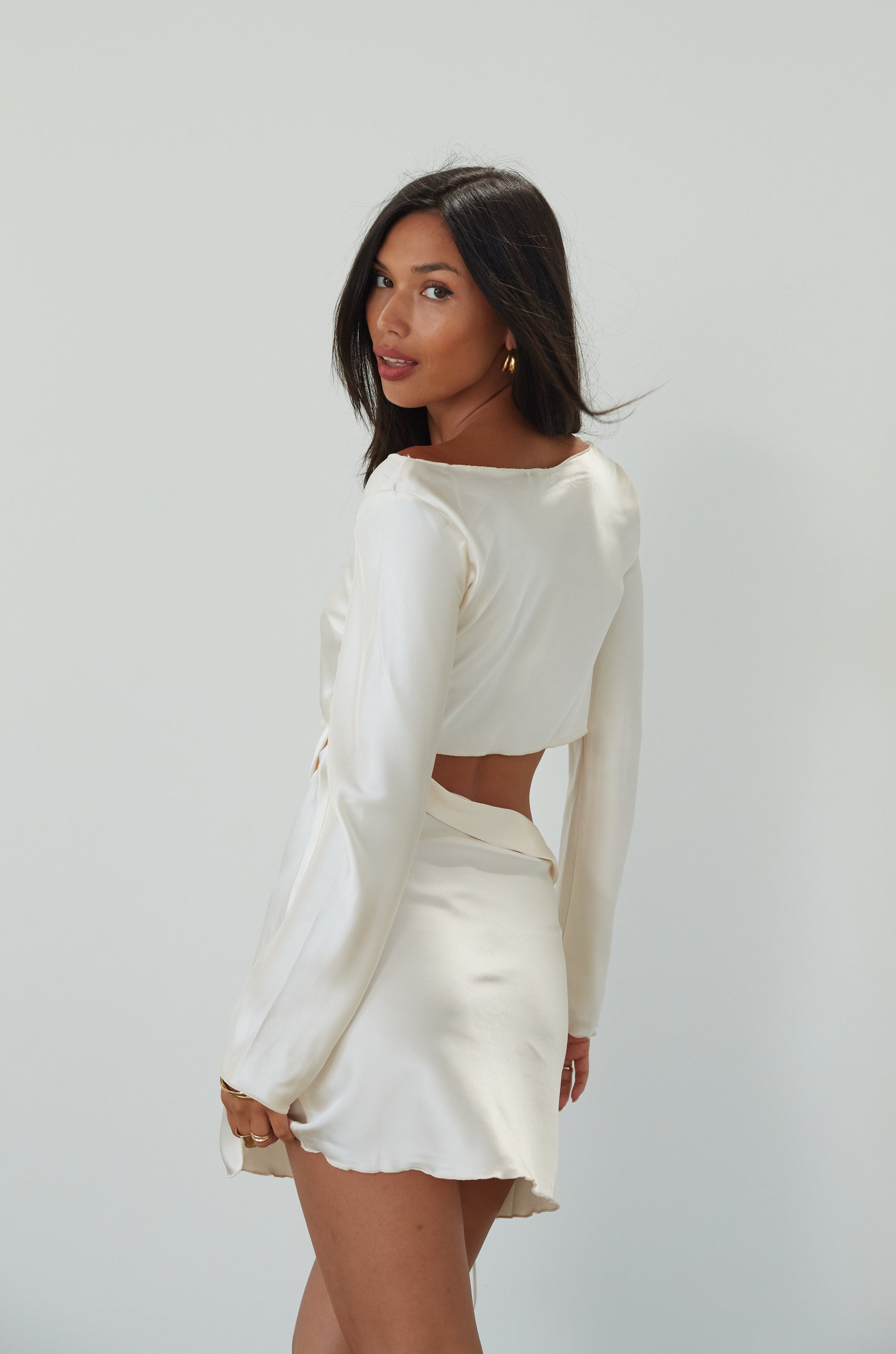 Satin dress. Long sleeves. Side cut out. Side zipper closure. Unlined. off white satin dress. off white mini dress. dress with cut out. cream satin mini dress. bride. bridal dress. engagement dress. bridal shower dress. wedding after party dress