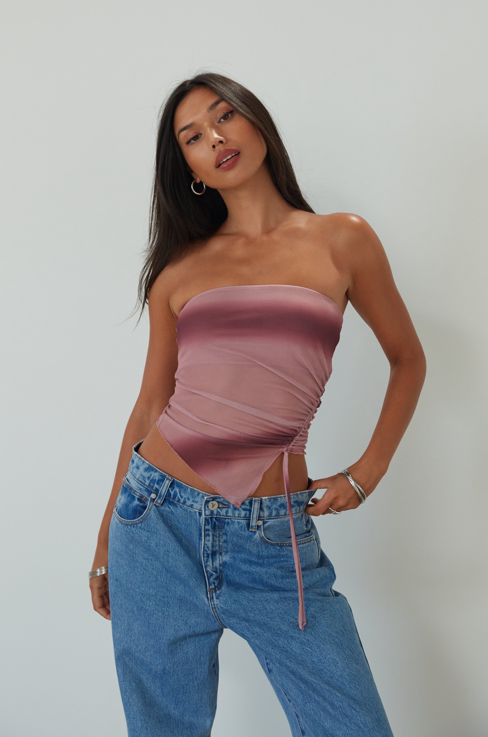 Tie dye knit mesh tube top. Elastic neckline. Side drawstring closure. Asymmetric hem. Partially lined. summer top. summer tube top. pink tube top. mesh tube top. going out top.