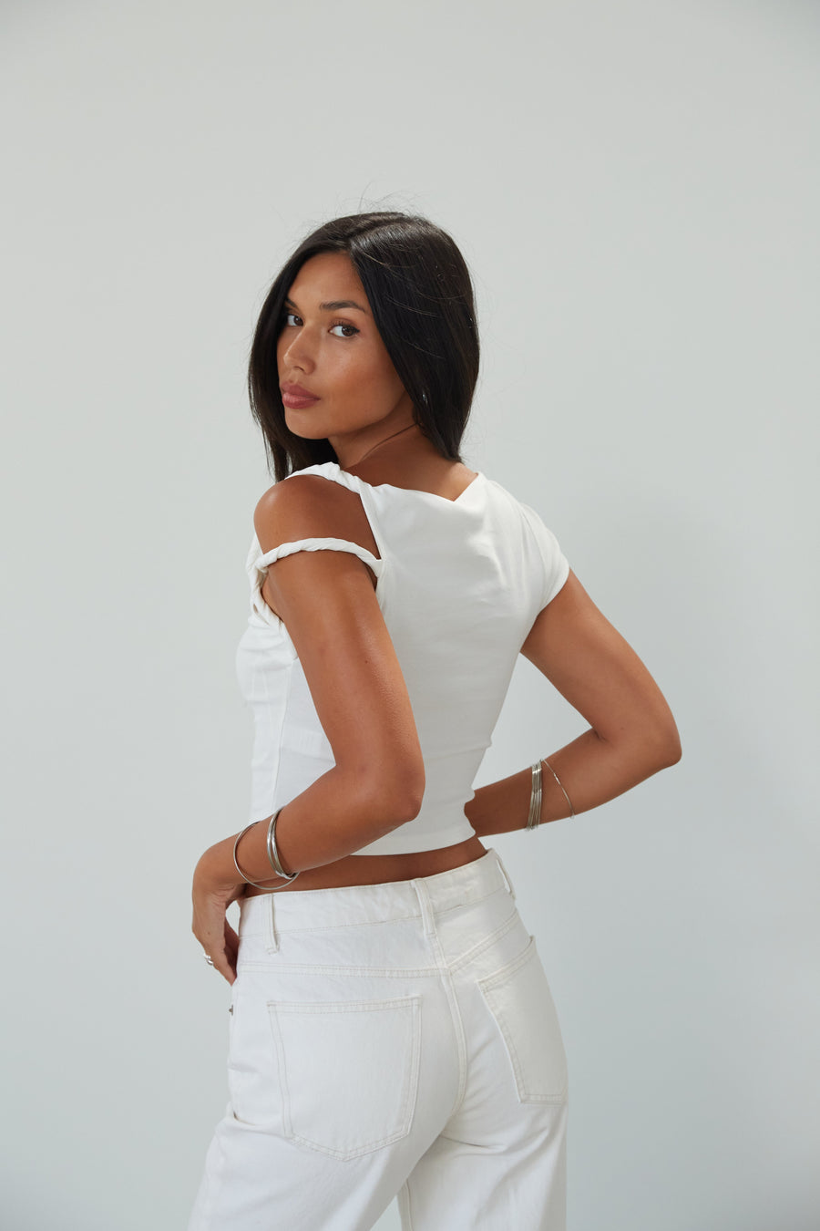 Knit crop top. Asymmetric sleeves. Unlined. white top. summer top. going out top. twist strap. white crop top