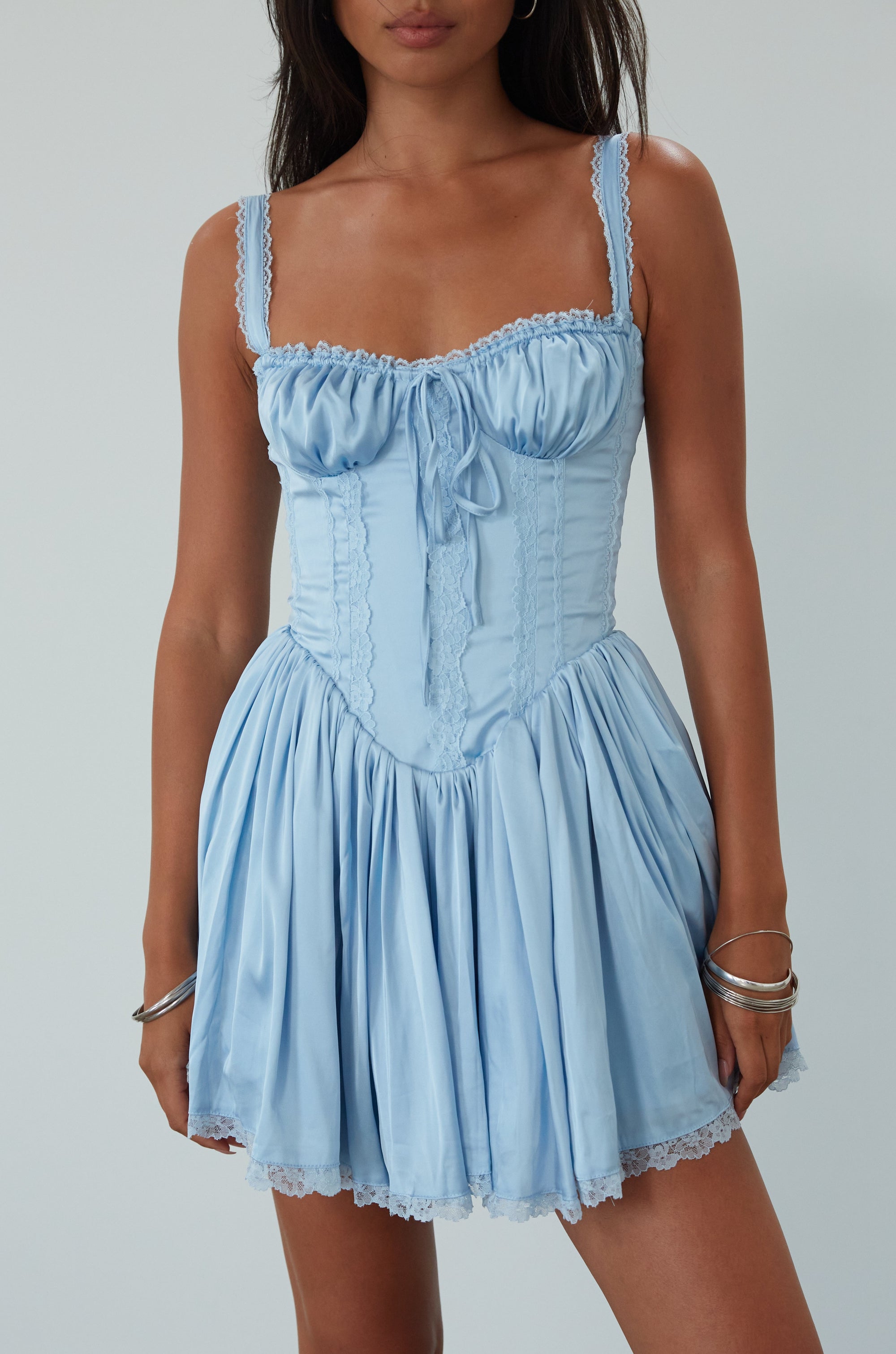Satin dress with lace trim. Adjustable straps. Front tie closure. Underwire cups. Boning in bodice. Back lace up closure. Elastic back waist. Fully lined. blue satin mini dress. summer dress. fancy mini dress.