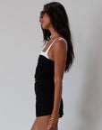 Black Knit mini skirt. Side&nbsp;hook and eye and zipper closures. Raw edge hem. Unlined.