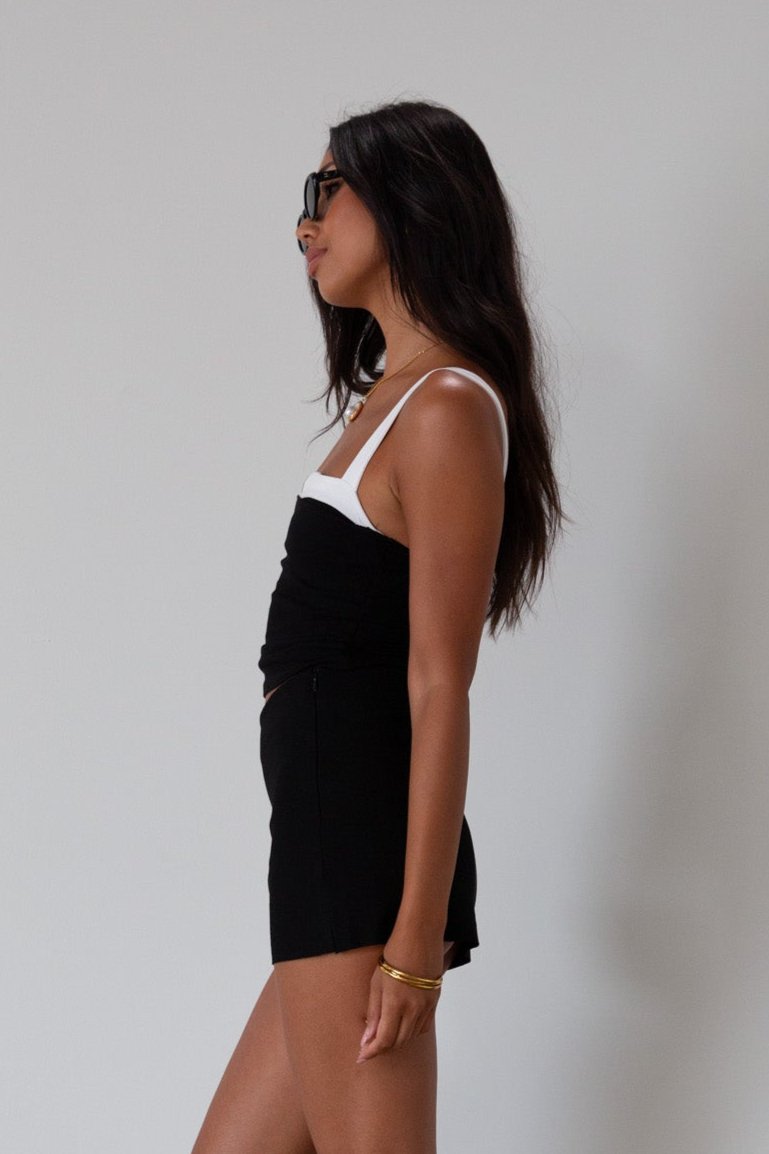Black Knit mini skirt. Side&nbsp;hook and eye and zipper closures. Raw edge hem. Unlined.