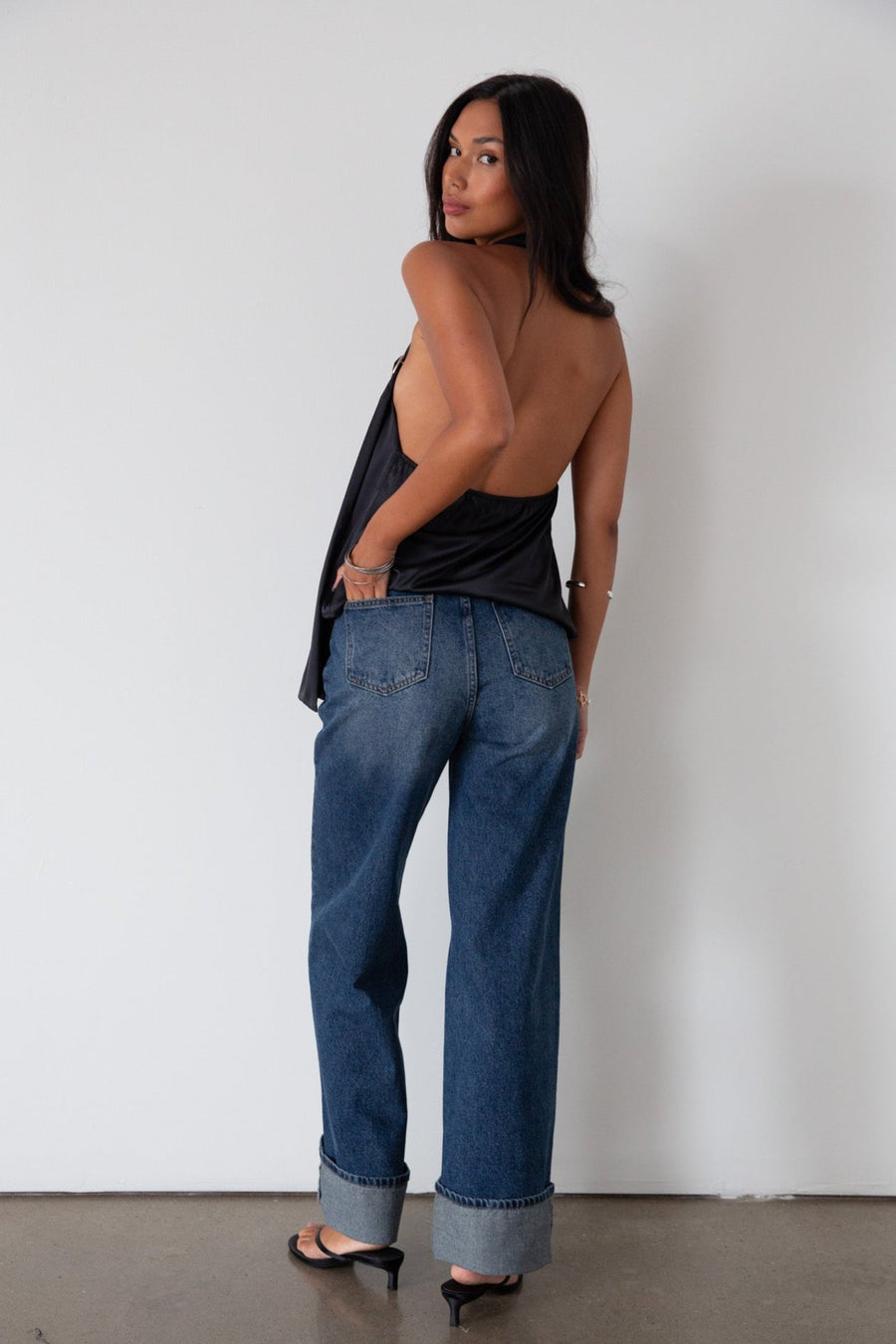 Denim wide leg jeans. Button and zipper fly. Five pocket construction. Cuffed hems. Unlined. dark wash denim jeans. fold up denim jeans. fold up pants. fold up jeans. 