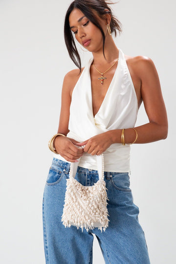 Small beaded bag. Fixed top strap. Top snap button closure. Fully lined.&nbsp;