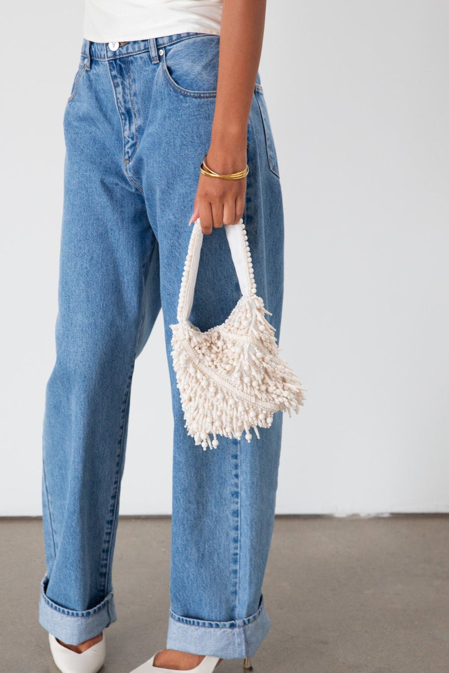 Small beaded bag. Fixed top strap. Top snap button closure. Fully lined.&nbsp;