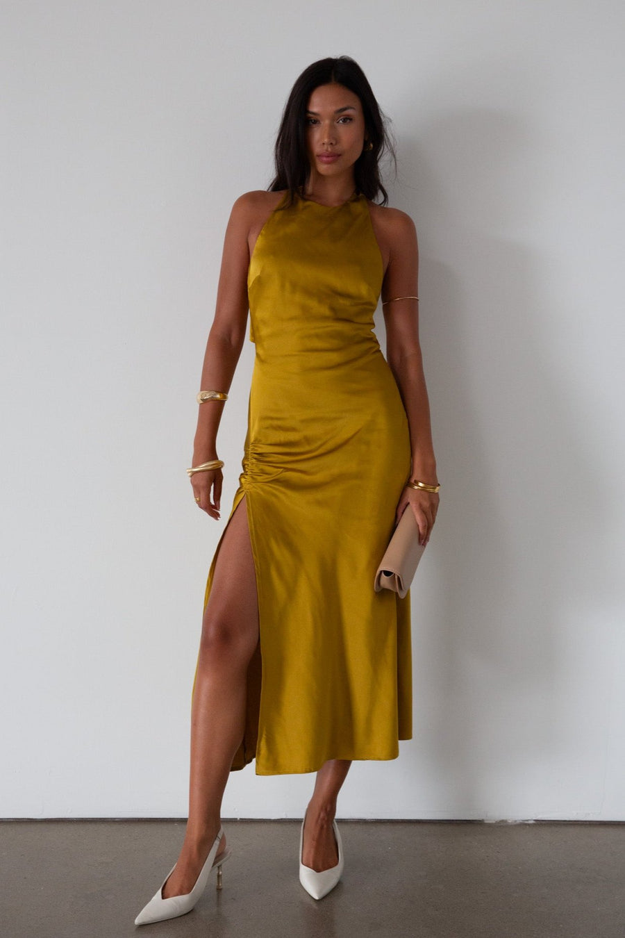 Satin maxi dress. Adjustable halter tie neckline. Side hook and eye and zipper closures. Front slit. Back tie closure. Partially lined. gold dress. gold midi dress. guest wedding dress. fall wedding. 