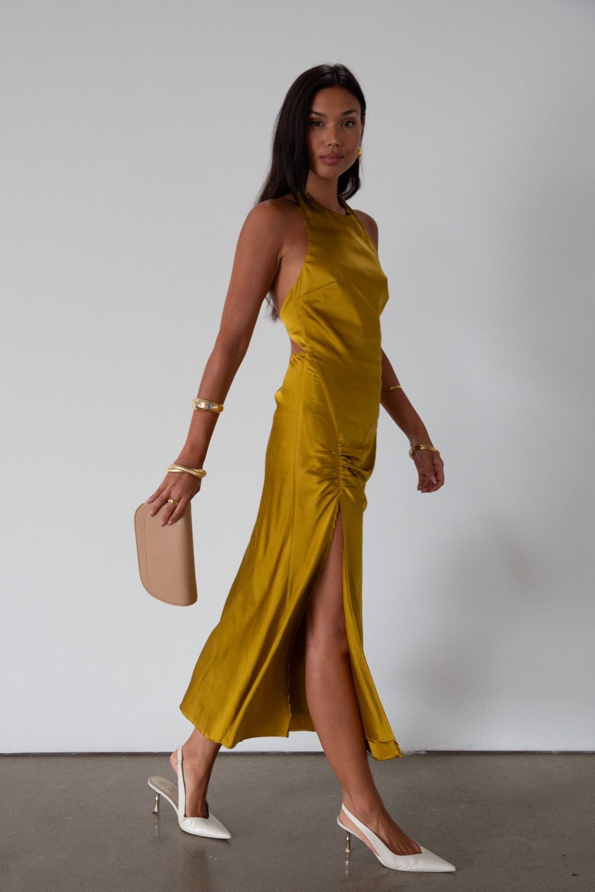 Satin maxi dress. Adjustable halter tie neckline. Side hook and eye and zipper closures. Front slit. Back tie closure. Partially lined. gold dress. gold midi dress. guest wedding dress. fall wedding. 