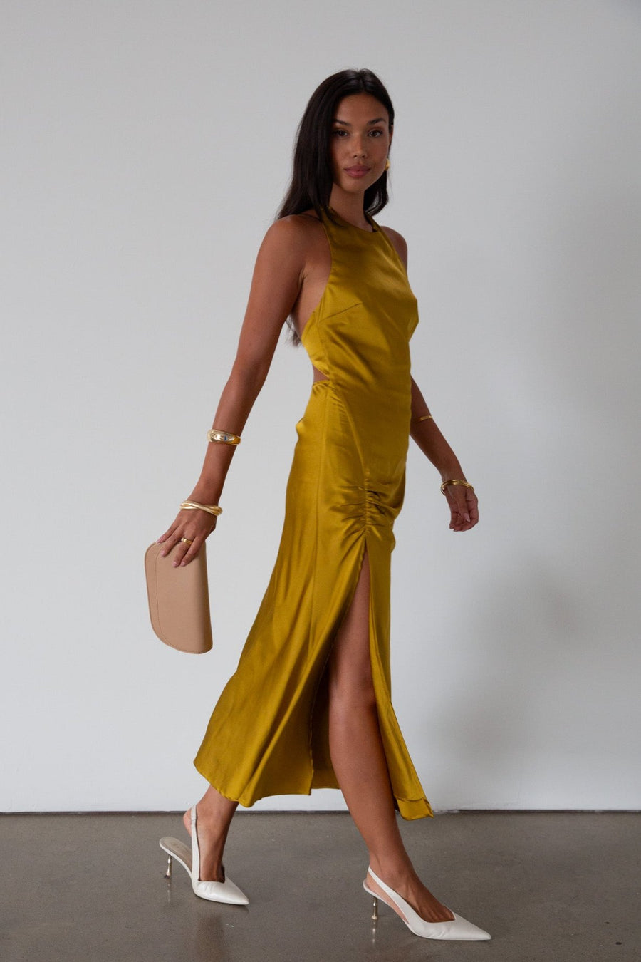 Satin maxi dress. Adjustable halter tie neckline. Side hook and eye and zipper closures. Front slit. Back tie closure. Partially lined. gold dress. gold midi dress. guest wedding dress. fall wedding. 