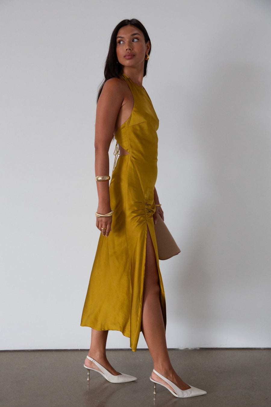 Satin maxi dress. Adjustable halter tie neckline. Side hook and eye and zipper closures. Front slit. Back tie closure. Partially lined. gold dress. gold midi dress. guest wedding dress. fall wedding. 