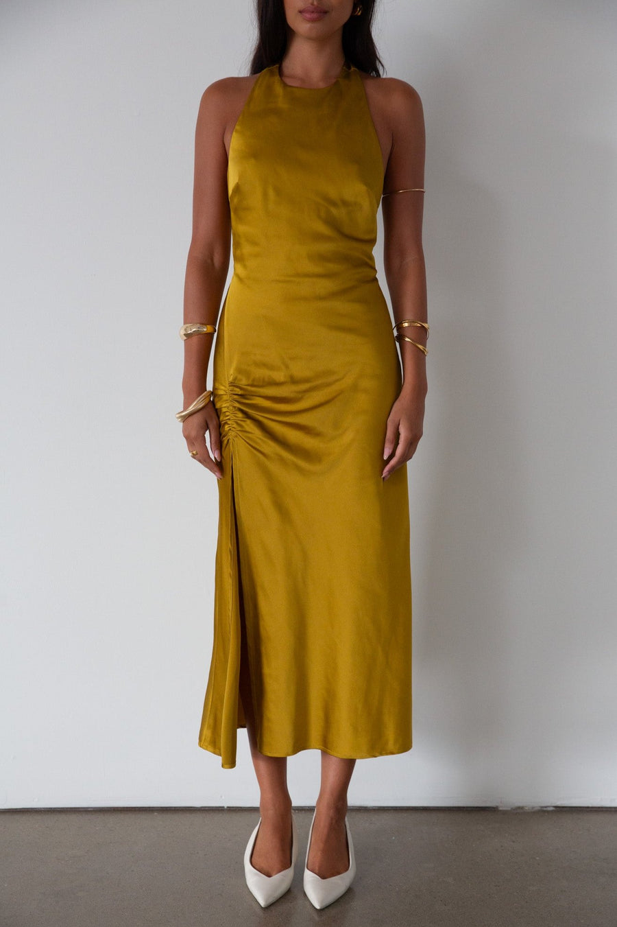 Satin maxi dress. Adjustable halter tie neckline. Side hook and eye and zipper closures. Front slit. Back tie closure. Partially lined. gold dress. gold midi dress. guest wedding dress. fall wedding. 