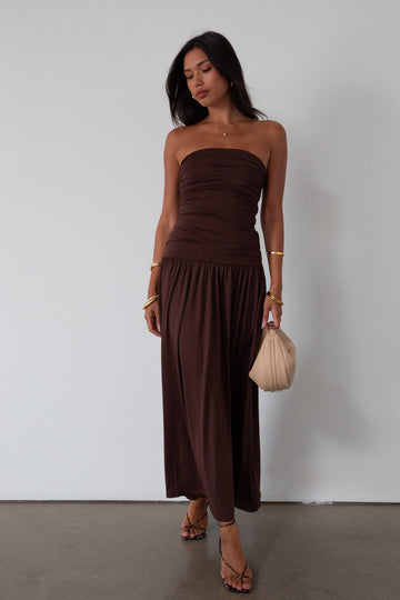 Knit maxi dress. Strapless elastic neckline. Inner rubber grip lining. Ruched slides. Partially lined. brown maxi dress. brown starpless maxi dress. summer dress. wedding guest dress