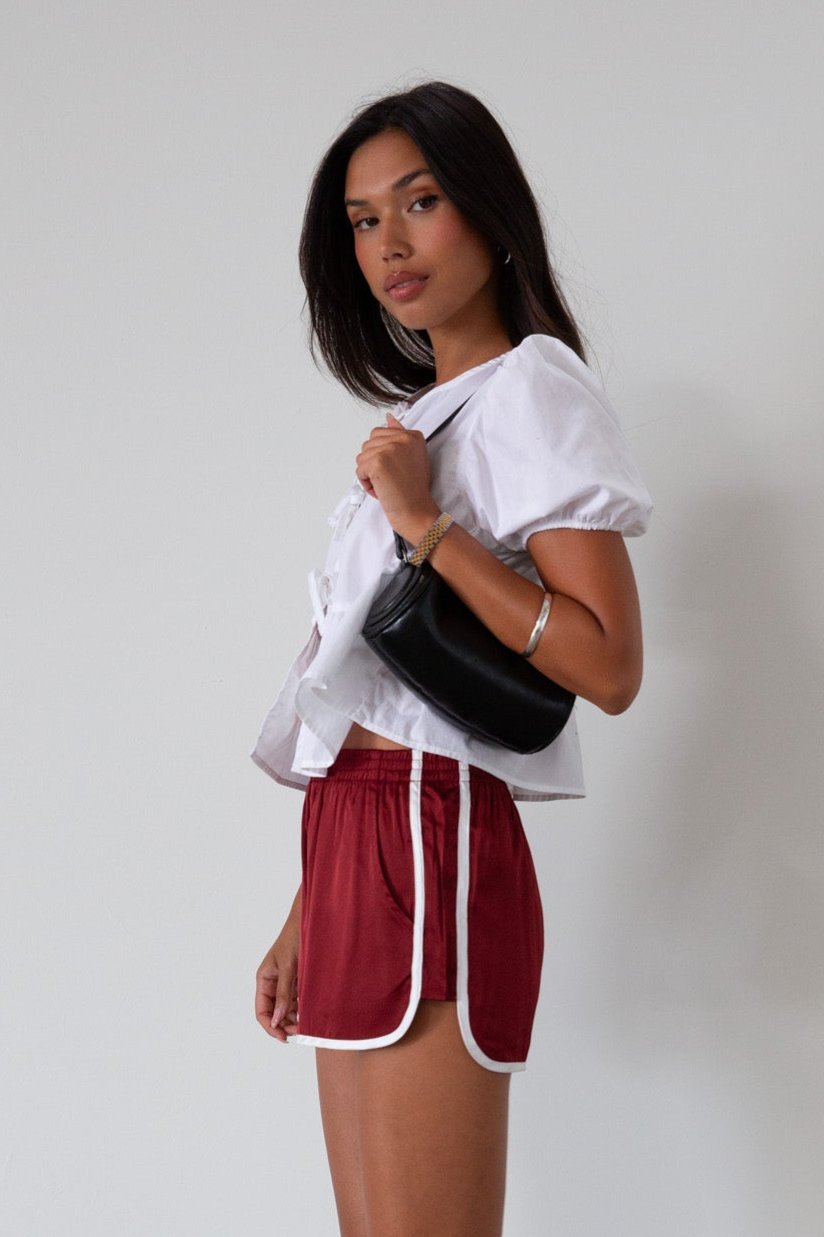 Satin shorts. Elastic waist. Side pockets. Unlined. cute track shorts. fashion track short. red shorts. red track shorts. 