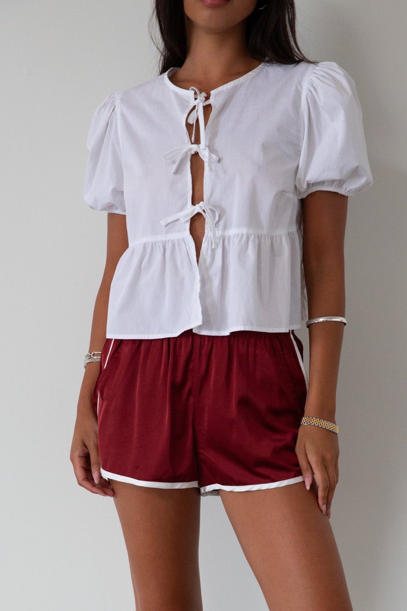 Satin shorts. Elastic waist. Side pockets. Unlined. cute track shorts. fashion track short. red shorts. red track shorts. 
