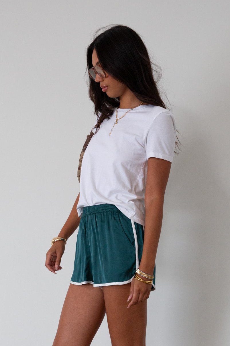 Satin shorts. Elastic waist. Side pockets. Unlined. cute track shorts. fashion track short. green shorts. green track shorts. 