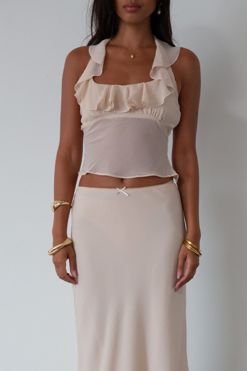 Chiffon crop top. Halter neckline with back button closures. Ruffle trimmed deep v-neckline. Side hook and eye and zipper closures. Partially lined. ruffle top. ruffle tank top. nude top. coquette top