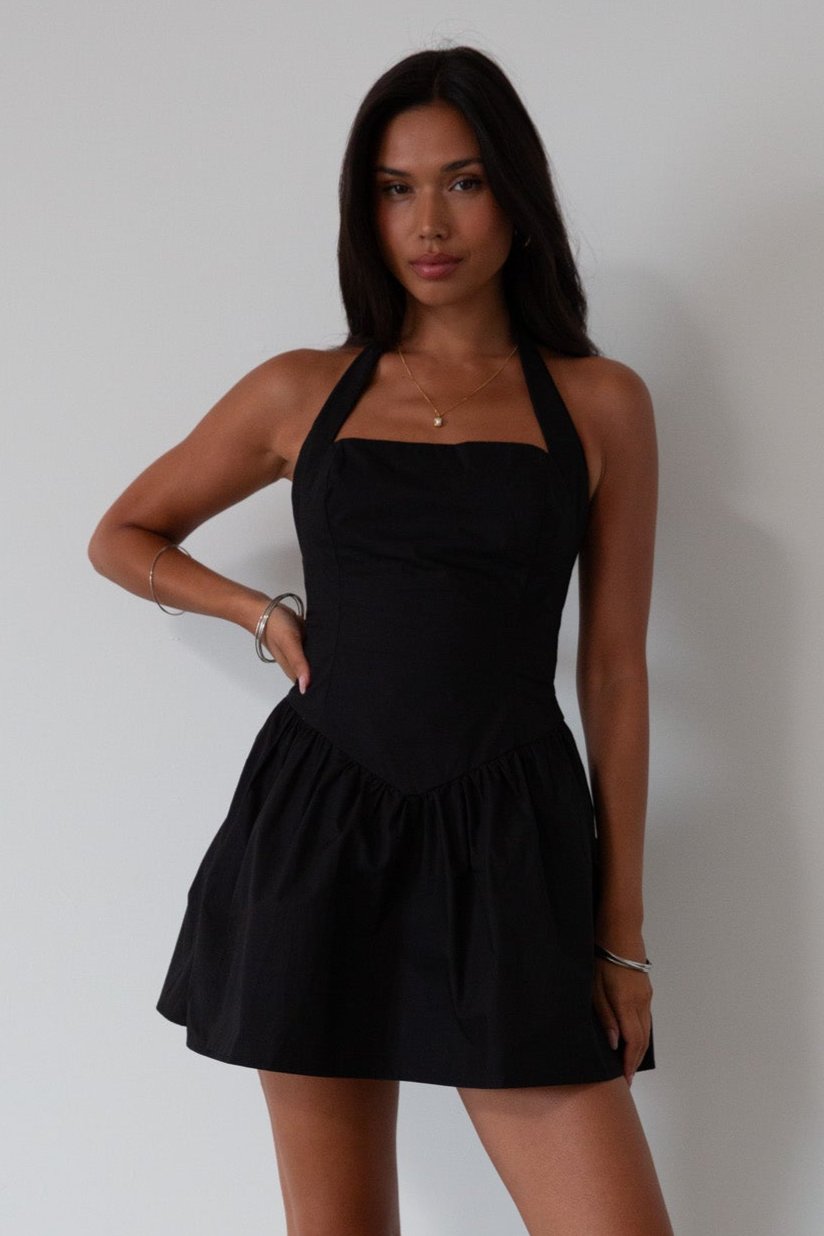 Woven dress. Halter neckline with button closures. Side pockets. Back hook and eye and zipper closures. Fully lined. black mini dress. black mini bubble dress. summer dress