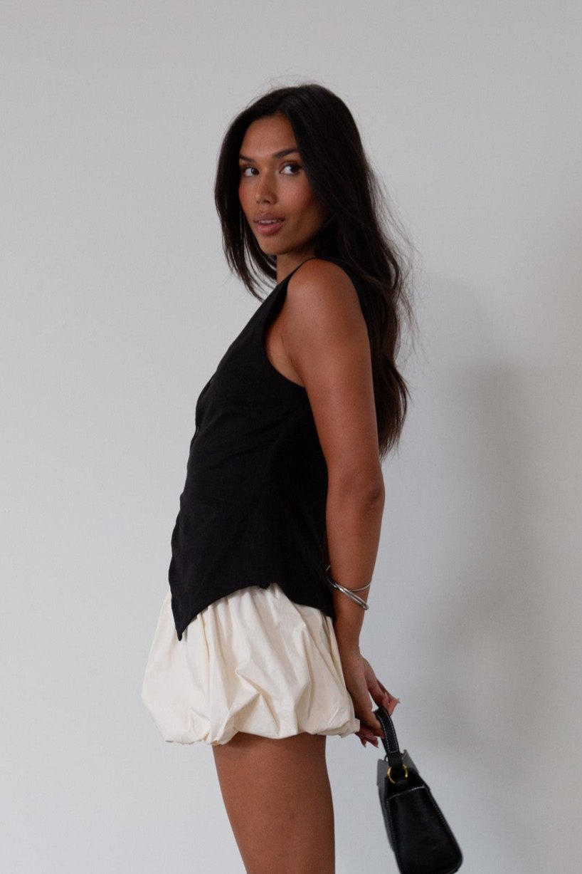 Woven skirt. Back hook and eye and zipper closures. Elastic bubble hem. Fully lined. cream bubble skirt. cream bubble mini skirt