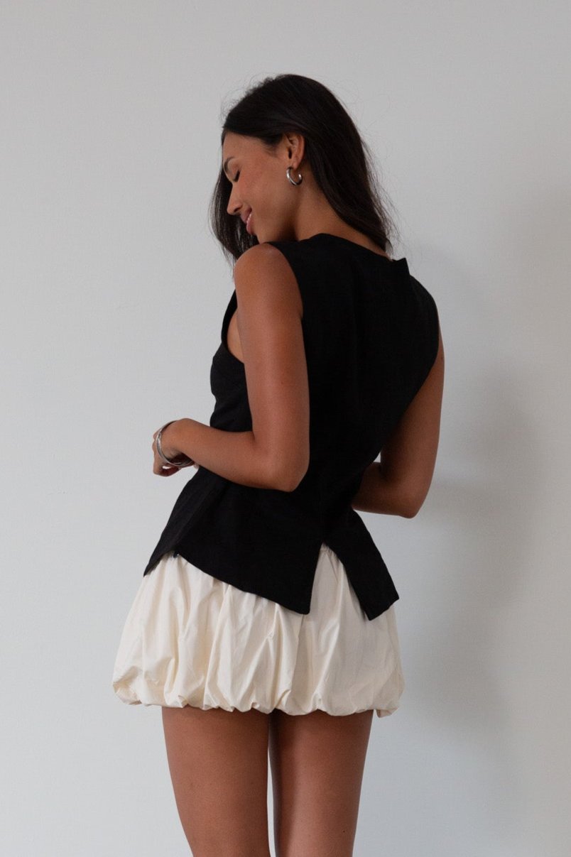 Woven skirt. Back hook and eye and zipper closures. Elastic bubble hem. Fully lined. cream bubble skirt. cream bubble mini skirt