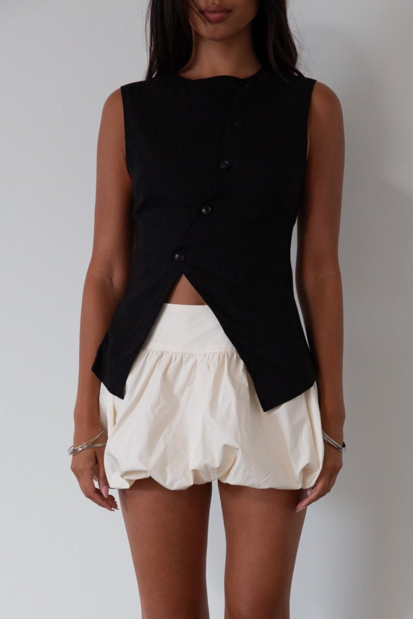 Woven skirt. Back hook and eye and zipper closures. Elastic bubble hem. Fully lined. cream bubble skirt. cream bubble mini skirt