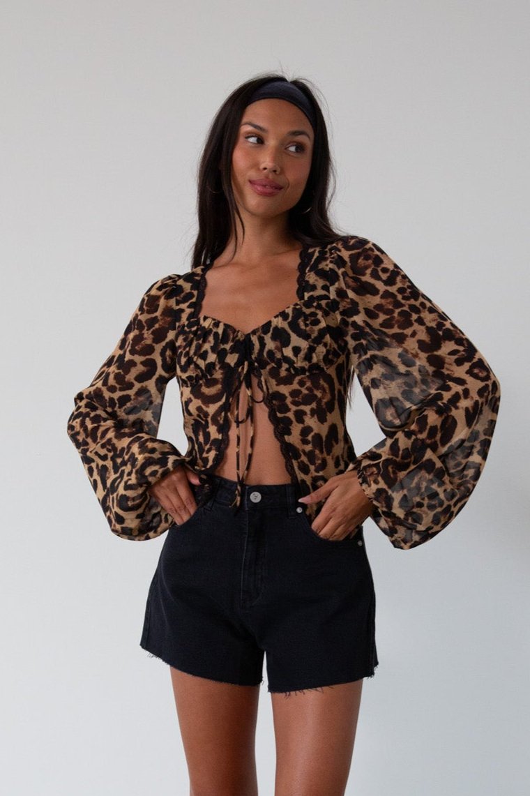 Animal printed chiffon top. Long sleeves with elastic openings. Underwire cups. Front lace up closures. Lace trim. Partially lined. leopard top. cheetah top. going out top. summer top