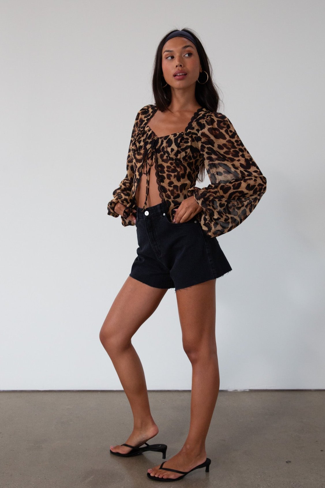 Animal printed chiffon top. Long sleeves with elastic openings. Underwire cups. Front lace up closures. Lace trim. Partially lined. leopard top. cheetah top. going out top. summer top