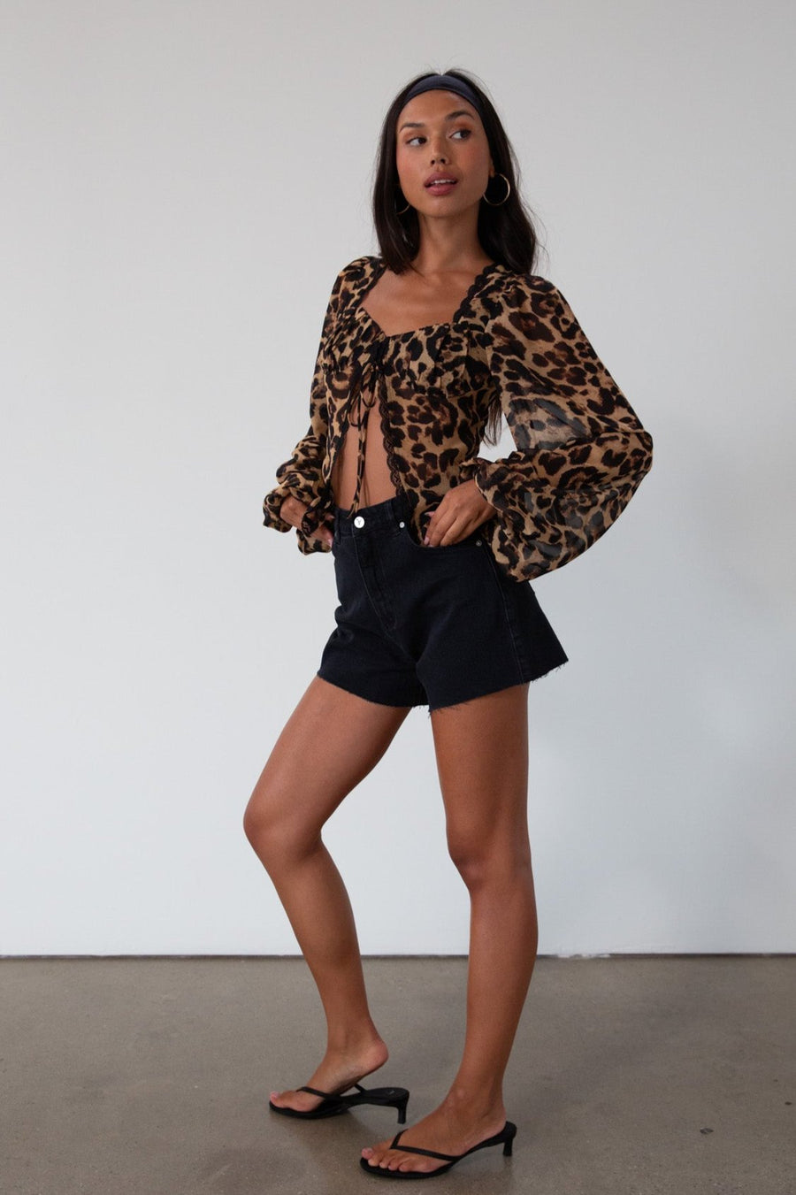 Animal printed chiffon top. Long sleeves with elastic openings. Underwire cups. Front lace up closures. Lace trim. Partially lined. leopard top. cheetah top. going out top. summer top