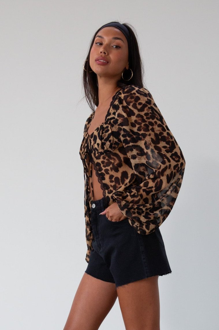 Animal printed chiffon top. Long sleeves with elastic openings. Underwire cups. Front lace up closures. Lace trim. Partially lined. leopard top. cheetah top. going out top. summer top