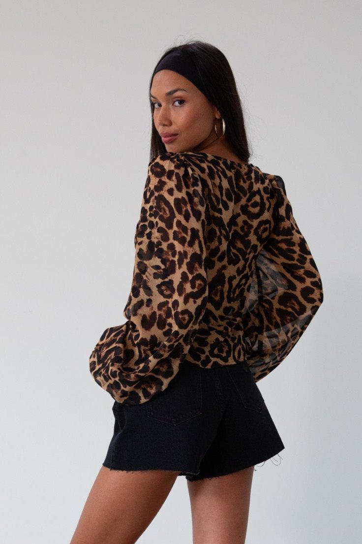 Animal printed chiffon top. Long sleeves with elastic openings. Underwire cups. Front lace up closures. Lace trim. Partially lined. leopard top. cheetah top. going out top. summer top