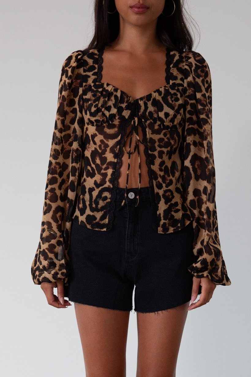 Animal printed chiffon top. Long sleeves with elastic openings. Underwire cups. Front lace up closures. Lace trim. Partially lined. leopard top. cheetah top. going out top. summer top